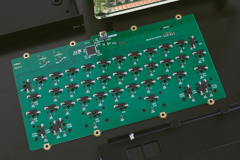 Keyboard circuit board lying next to other disassembled parts