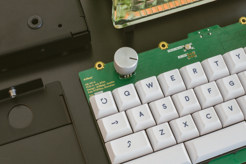 Close-up of disassembled keyboard parts including circuit board