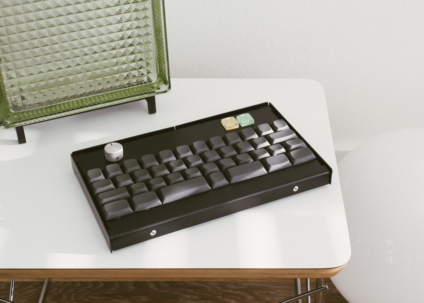 Keyboard sitting on a table next to two lamps